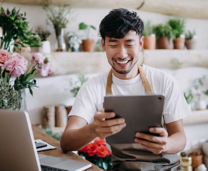 Male business owner using device.