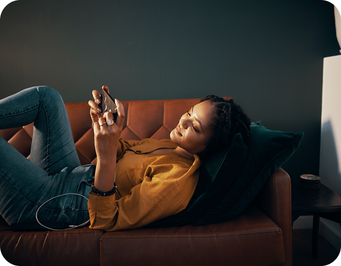 Woman on couch looking at cell phone
